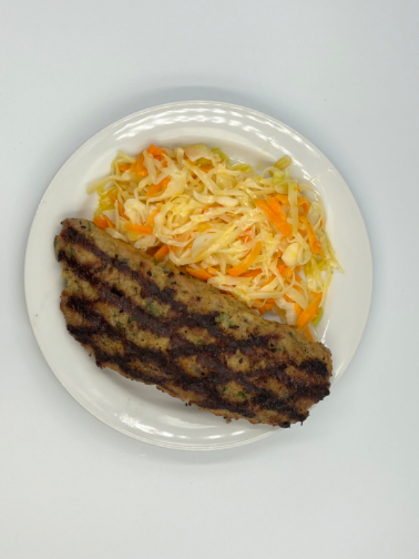 Pork burger stuffed with feta cheese and tomato